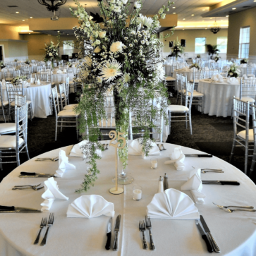 Bulk Mariposa Table Linen Banquet hall with table settings and centerpieces for wedding reception